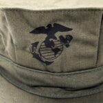 a US Marine Corps Eagle, Globe, and Anchor symbol printed on an olive green USMC sateen 8-point utility cover