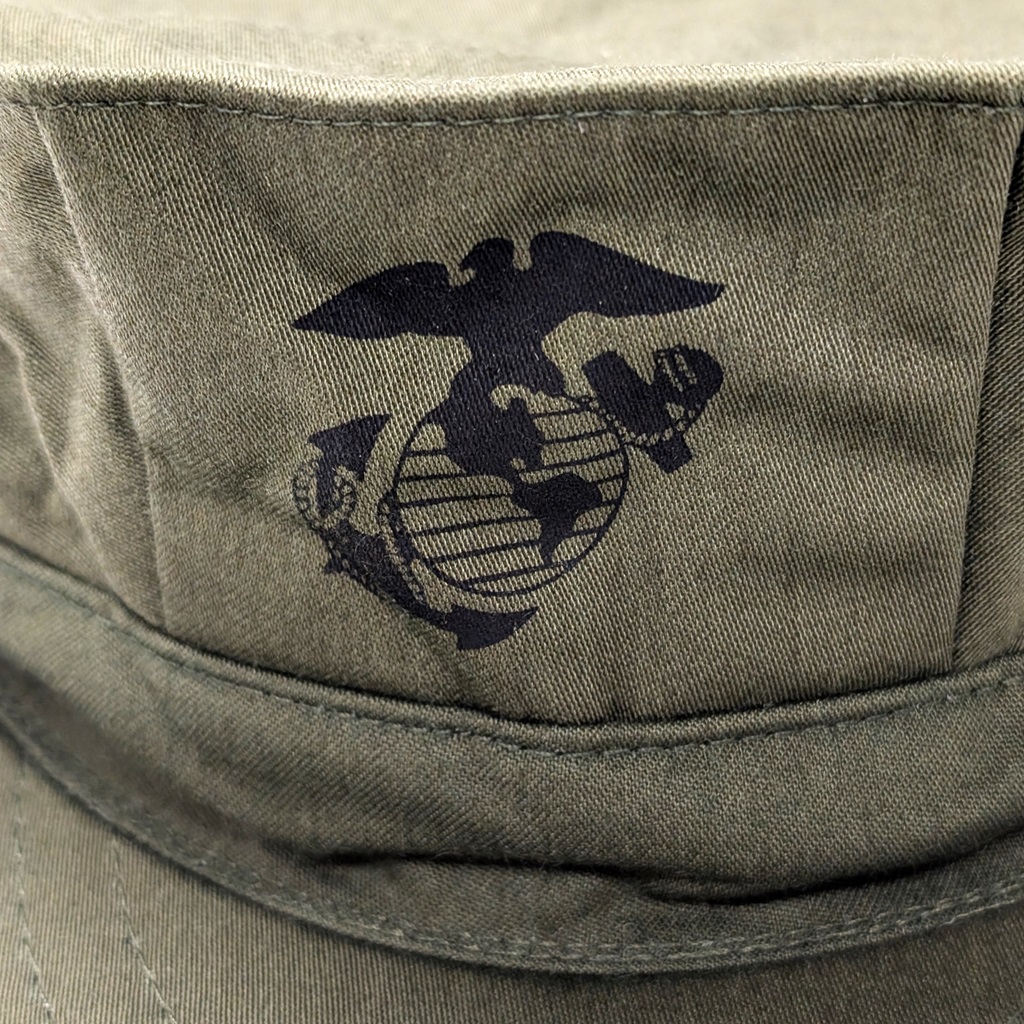 a US Marine Corps Eagle, Globe, and Anchor symbol printed on an olive green USMC sateen 8-point utility cover