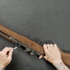 Cleaning Rifle with Cotton Swab