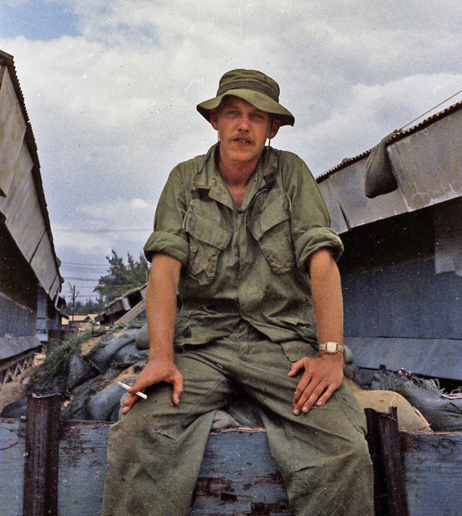 a man wears a jungle hat in the streets of Hanoi in the 1970s
