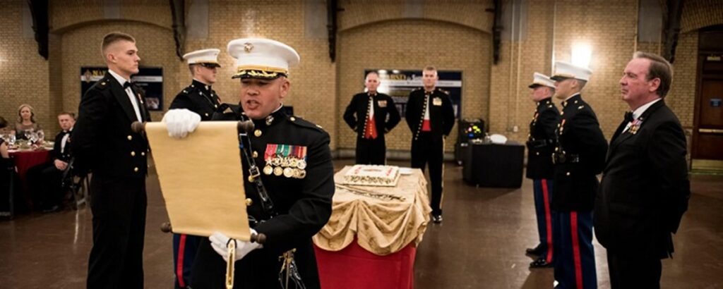an officer reads the Marine Corps Order No. 47, Series 1921 at a Marine Corps ball