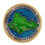 a silver gold, blue, and green challenge coin with a depiction of the Hawaiian island of O'ahu and the words "RIMPAC," "Marine Corps Base Hawaii," and "Capable, Adaptive, Partners."