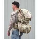 a Marine wearing a desert MARPAT FROG combat shirt wears a 3-color desert USGI MOLLE II Large Ruck Sack