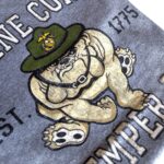 a vintage-look US Marine Corps charcoal gray t-shirt with an weathered Marine Corps bulldog mascot with the words "MARINE CORPS" "SEMPER FI" and "EST 1775"