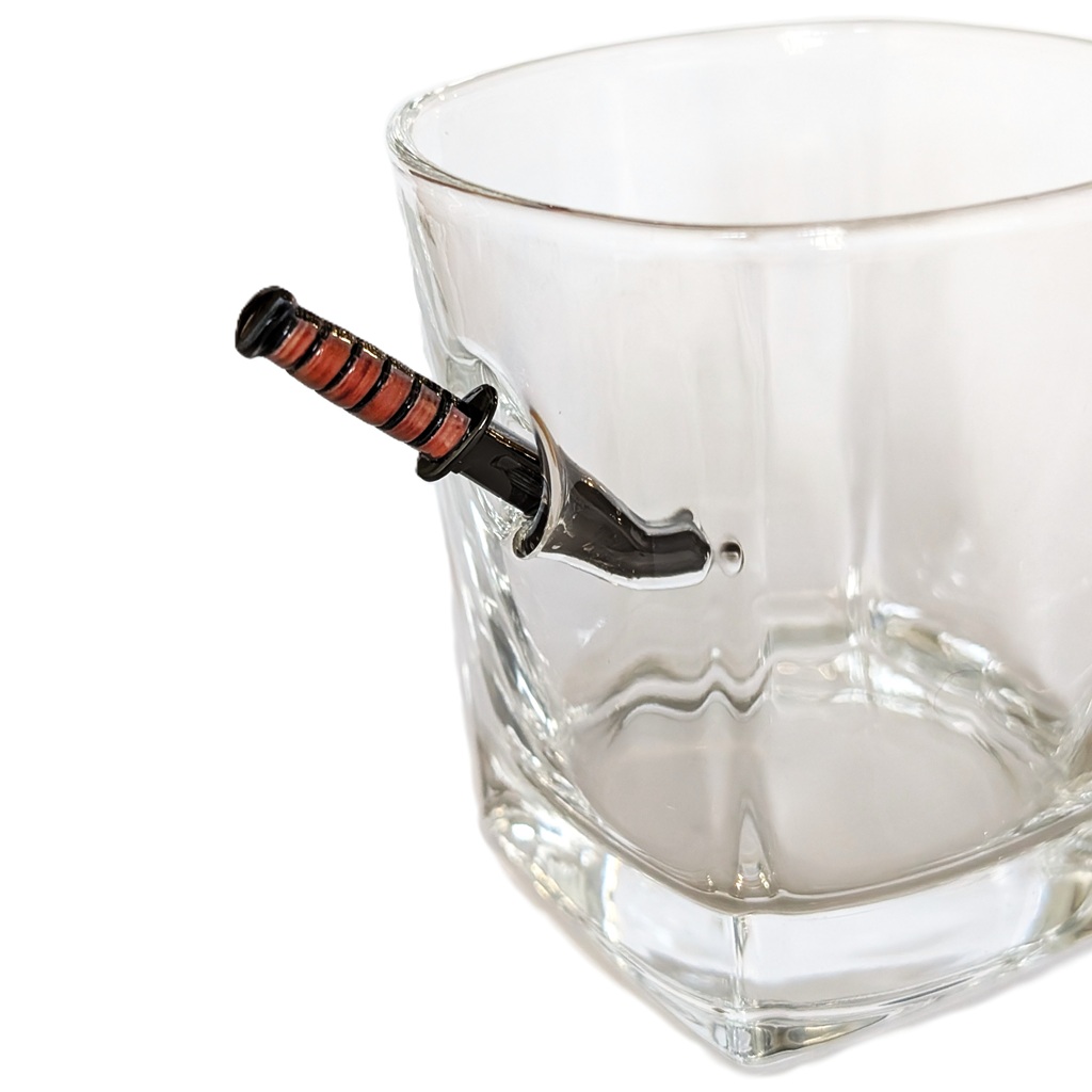 a US Marine Corps whiskey glass with a miniature KABAR combat utility knife replica sticking into the glass