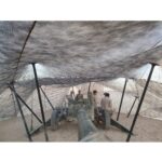 US Marines under camo netting