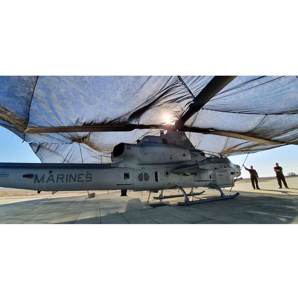 a Marine helicopter under ULCANS camo net